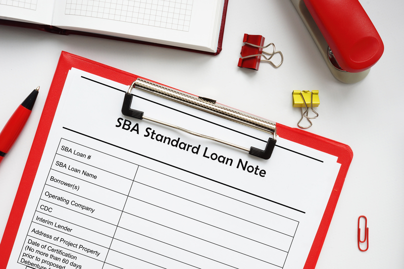 A red clipboard holds a form titled 